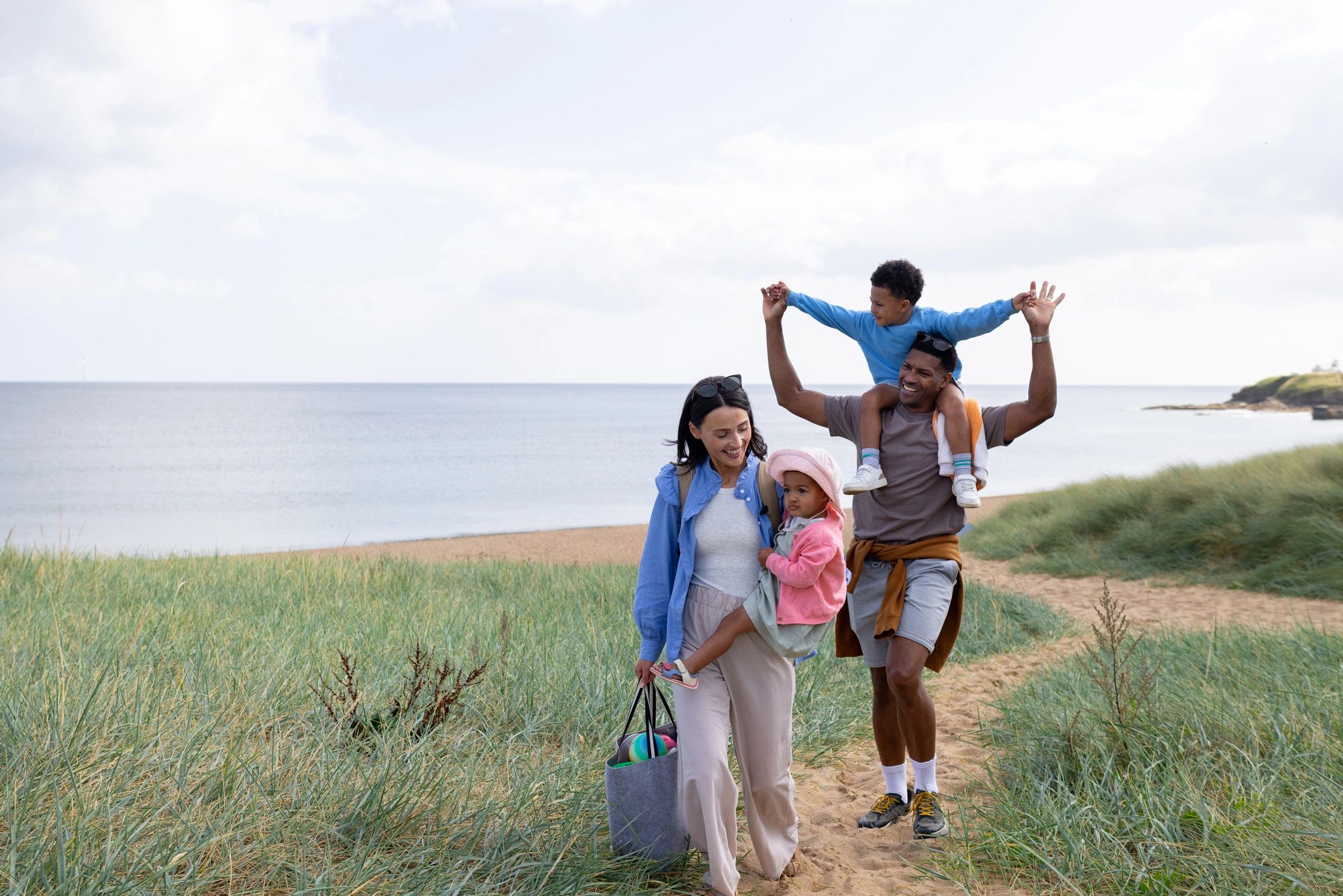 Family walking together near the beach on a sunny trip